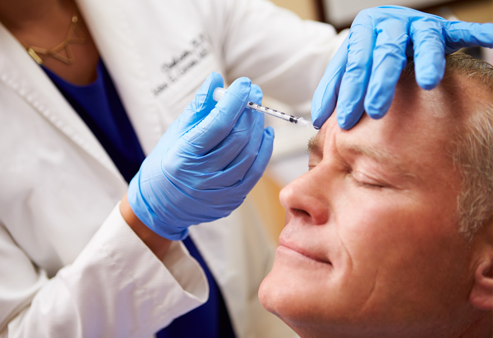 Photo of a man injecting botox in his face